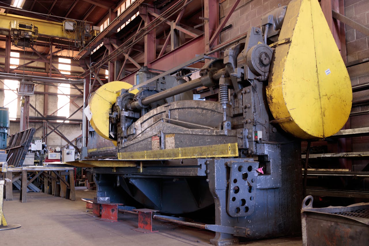 Services Heavy-duty industrial machine in a factory's production line, showcasing machinery details.
