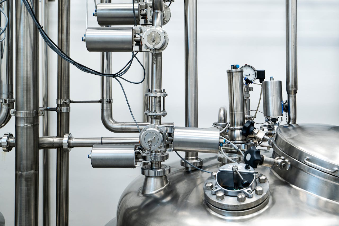 Mastering the First Impression: Your intriguing post title goes here Close-up of stainless steel machinery and pipes in an industrial setting, showcasing modern engineering.