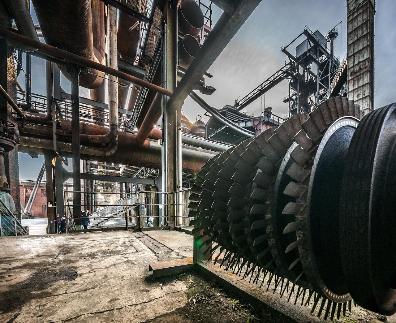 The Art of Drawing Readers In: Your attractive post title goes here Detailed view of large industrial machinery in a factory with steel structures and pipes.