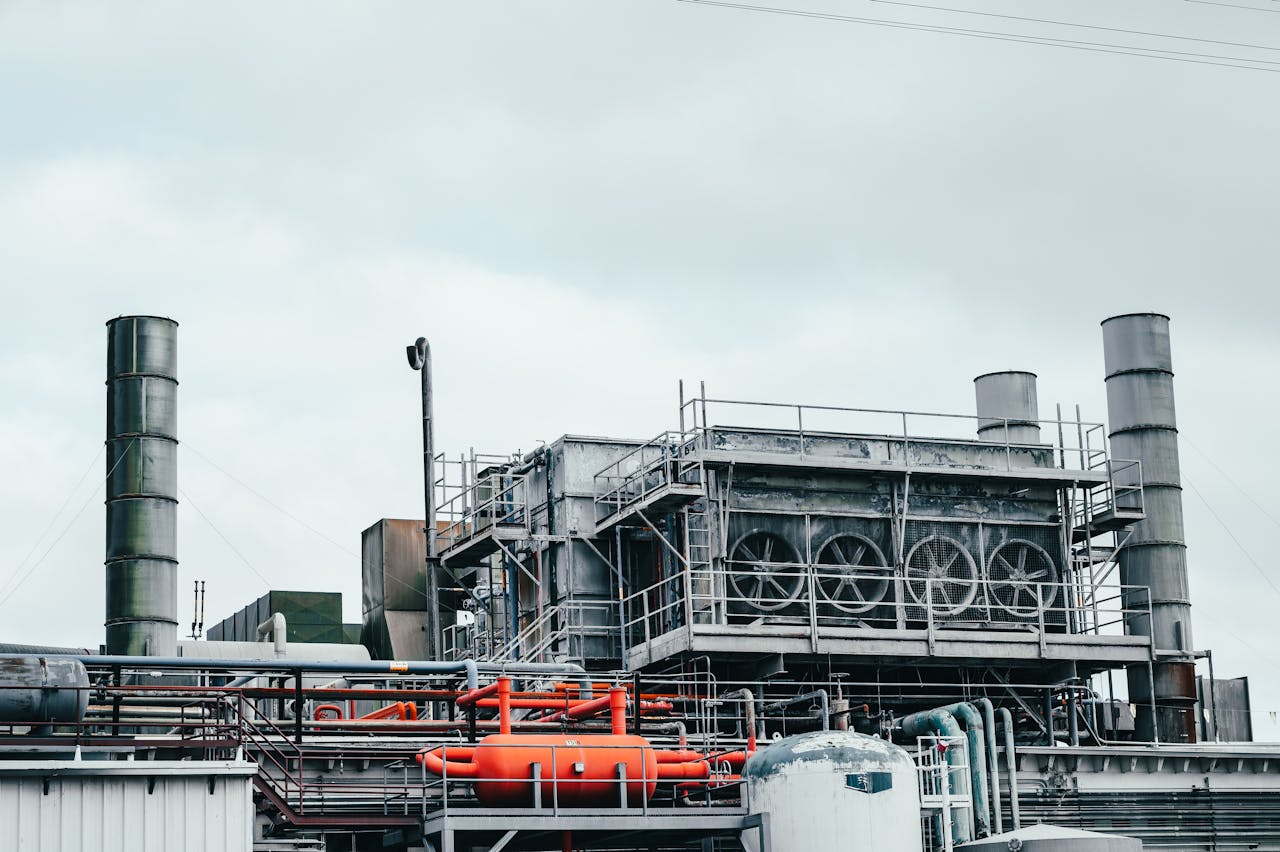 Crafting Captivating Headlines: Your awesome post title goes here Industrial factory with metal pipes and special equipment surrounded with fences located against cloudy sky on street with power lines in town